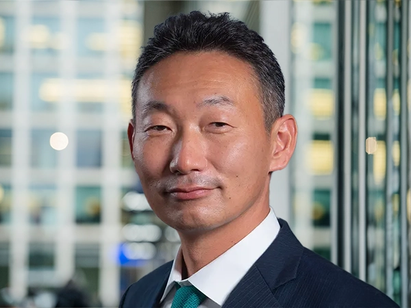 Portrait of Hiisanao Kajiura, Managing Director, Japan, standing in window based office building.
