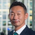 Portrait of Hiisanao Kajiura, Managing Director, Japan, standing in window based office building.