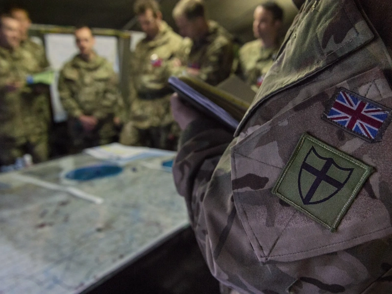 Close up of British Army camouflage uniform with the Union Jack flag sewn on the pocket.