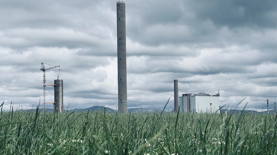 Factory in a landscape with green grass