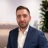 Portrait of Paul Barry, Data Centre Sector Lead, NAM, standing in plant based office in blue blazer.
