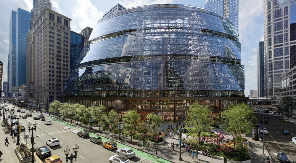 The Google Thompson Center in Chicago, a 17-storey, glass fronted building set to a backdrop of cars and greenery.