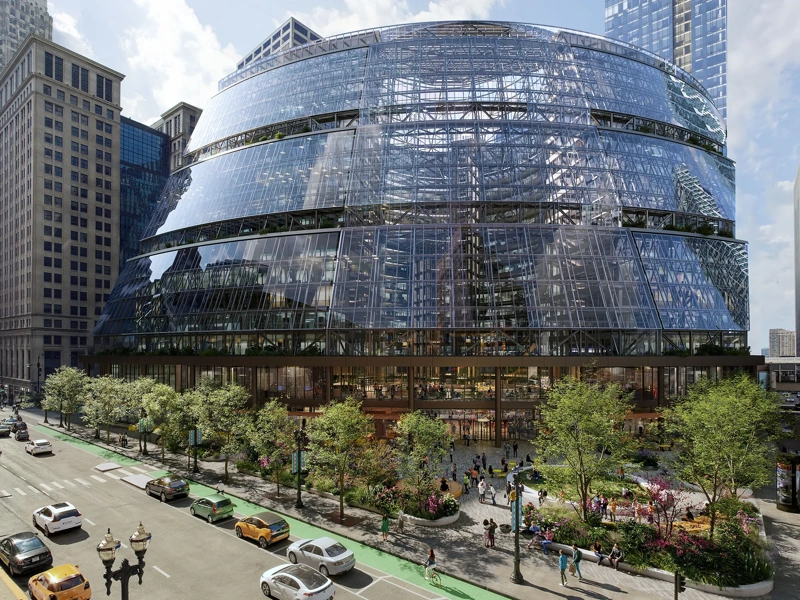The Google Thompson Center in Chicago, a 17-storey, glass fronted building set to a backdrop of cars and greenery.