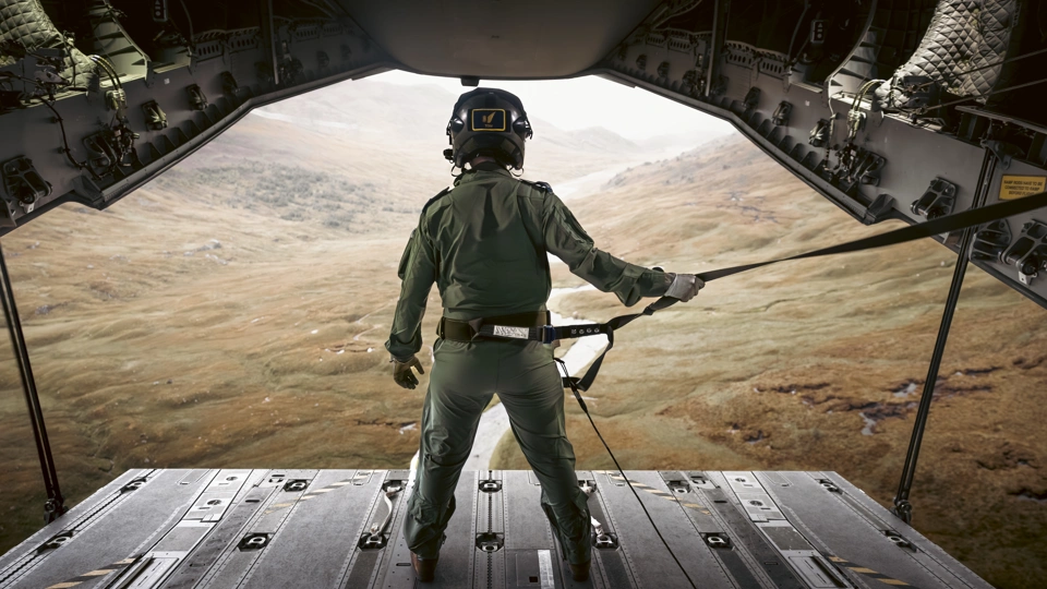 An RAF Atlas C.1 A400M Load Master looks out to the Cairngorm mountains whilst ramp riding during a low level training sortie through the Scottish Highlands.