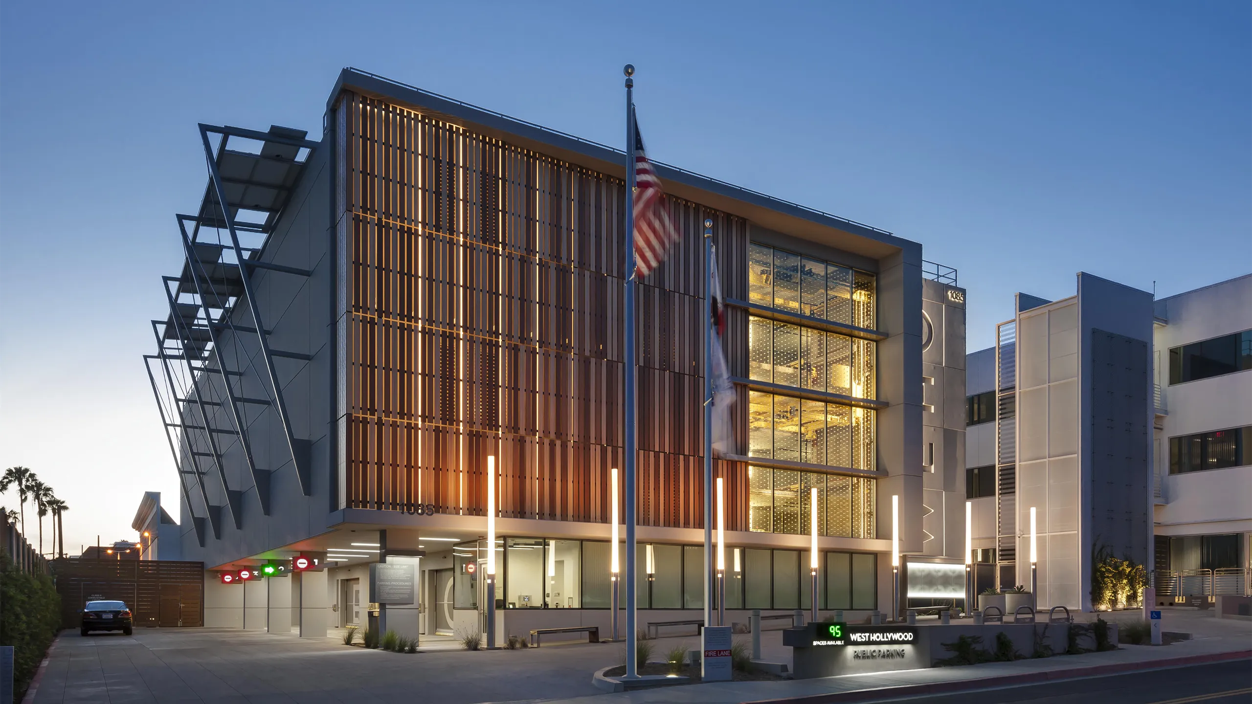 Exterior of a well lit, modern building at dusk