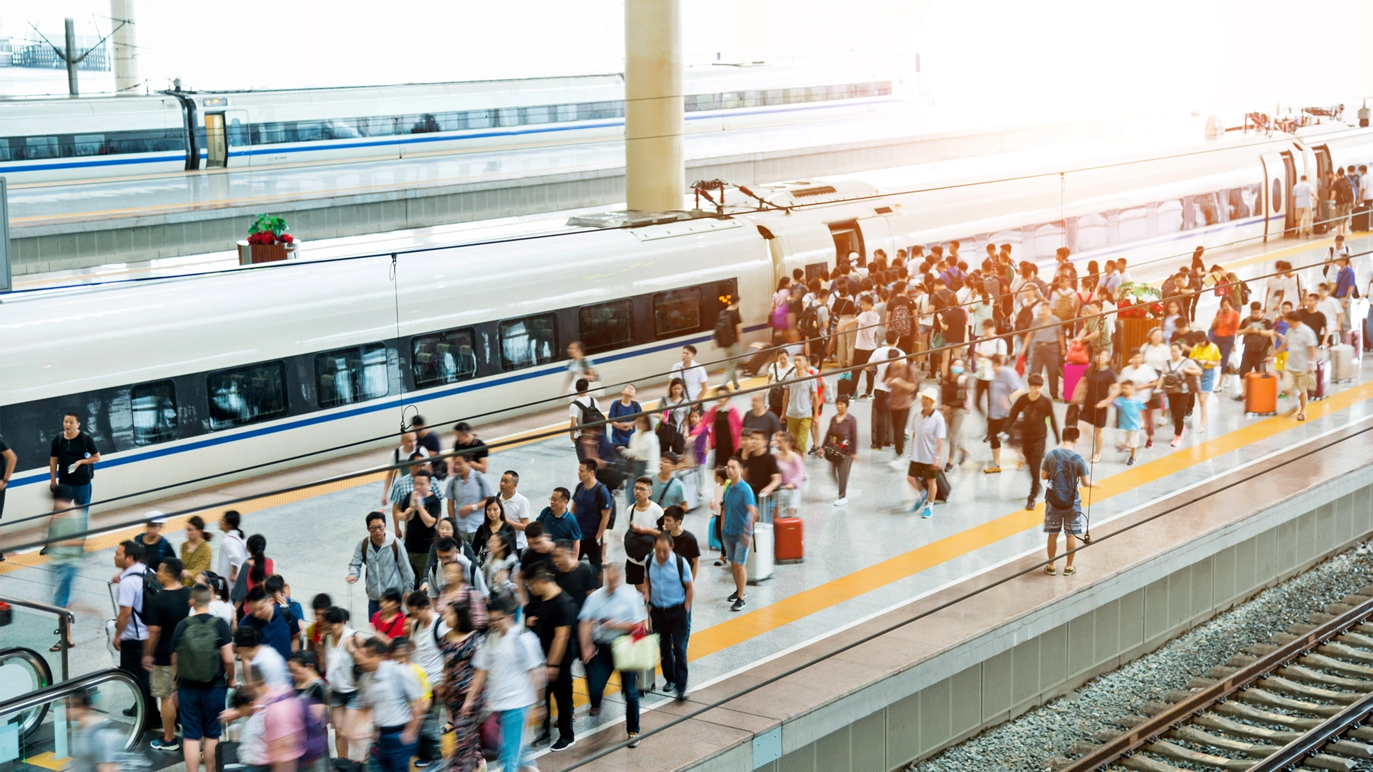 Crowd Of Passengers Waiting On Station Platform.