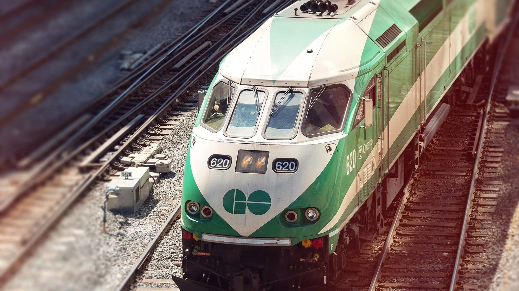 Frontal shot of a green Ontario Metrolinx train on tracks, Toronto, Canada