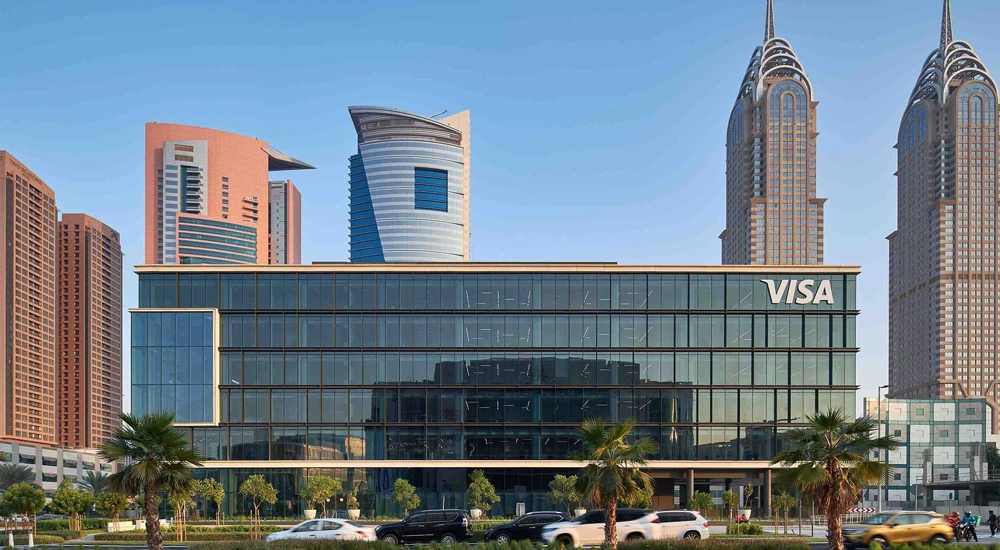 VISA headquarters with glass exterior facade and skyscrapers in the background, Dubai, UAE