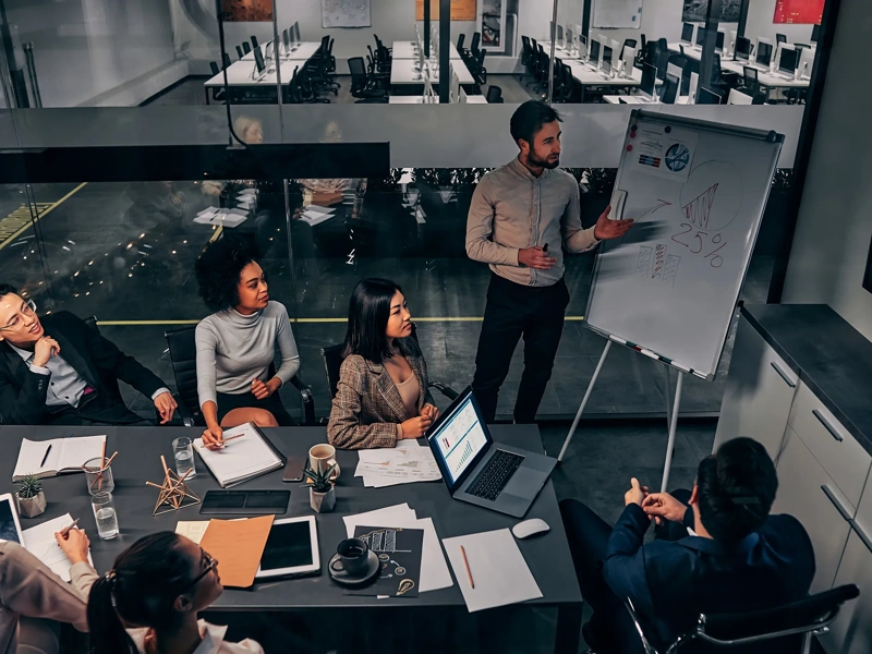 Business presentation. A group of handsome business people working in a spacious conference room in a large business center. Concept of startup, projects, planning, results, strategy.