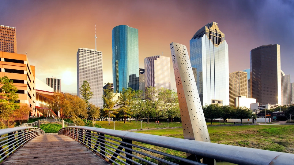 Collection of skyscrapers over a bridge at sunset