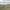 Portrait of highway surrounded by green fields and river.
