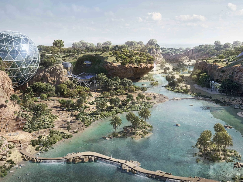 An image of King Salman Park with a blue river running through the middle of a green area and a futuristic, silver dome on the left bank.