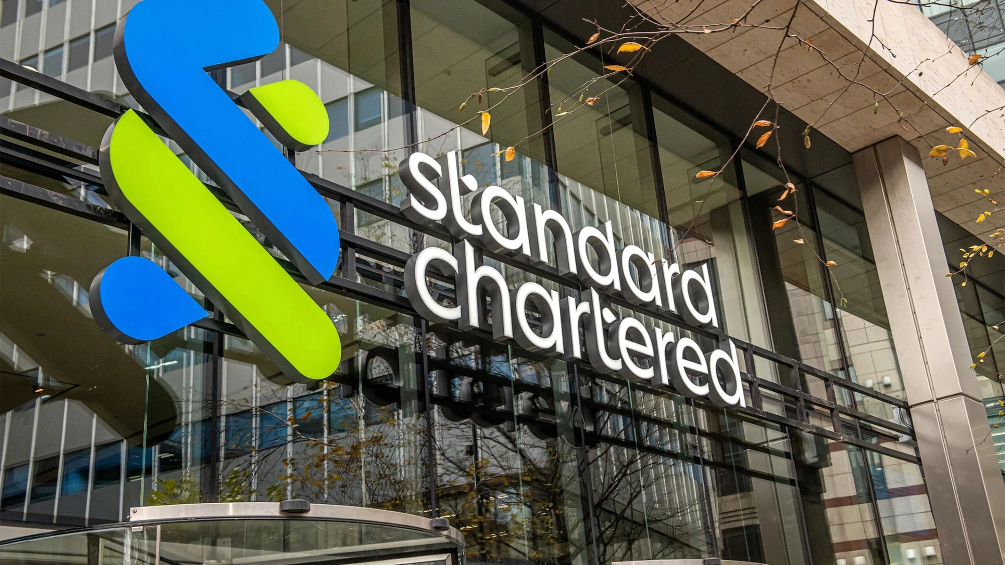 Standard Chartered glass office front with logo, London, UK
