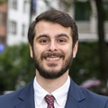 Portrait of Nima Aase, Managing Director, Scandinavia, outside in front street with trees and tall buildings,