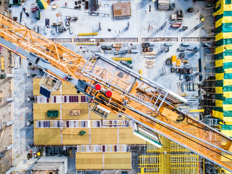 Nadir view of an industrial site, with cranes, concrete work, and more.