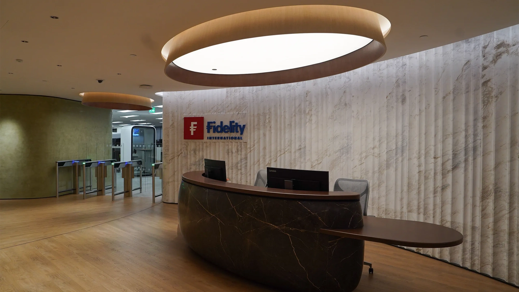 Fidelity office reception with brown marble front desk and logo