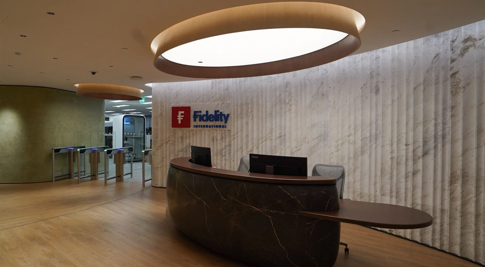 Fidelity office reception with brown marble front desk and logo