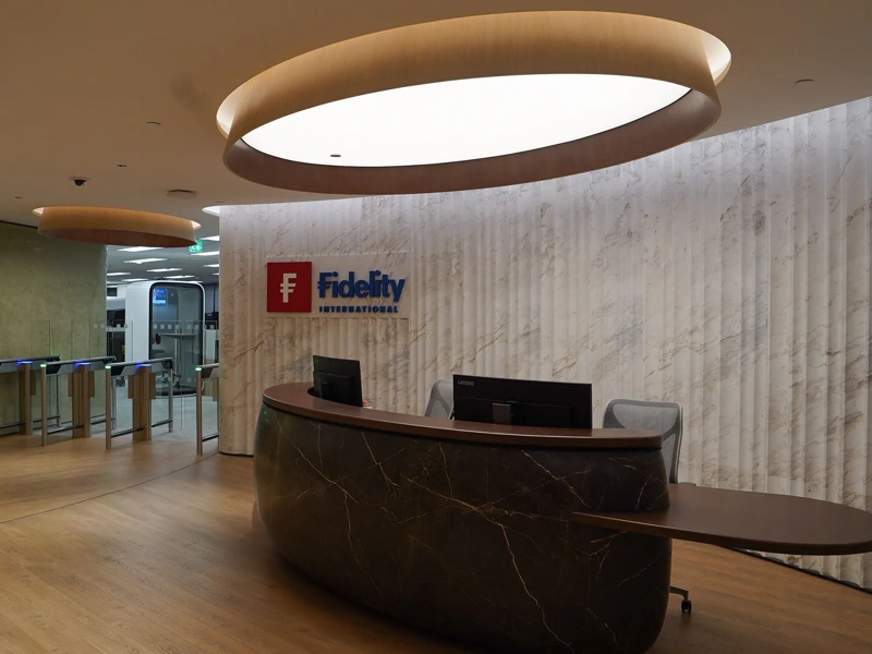 Fidelity office reception with brown marble front desk and logo