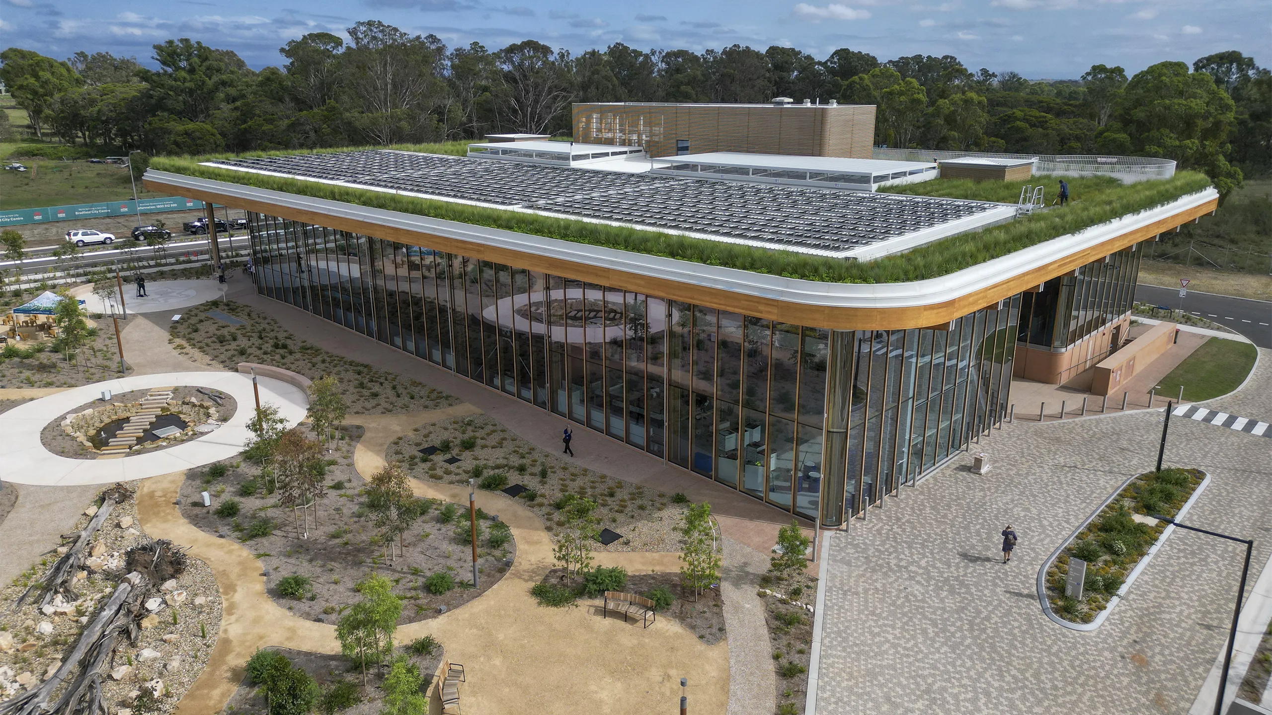 BDA first building with green grass on roof and glass windows.