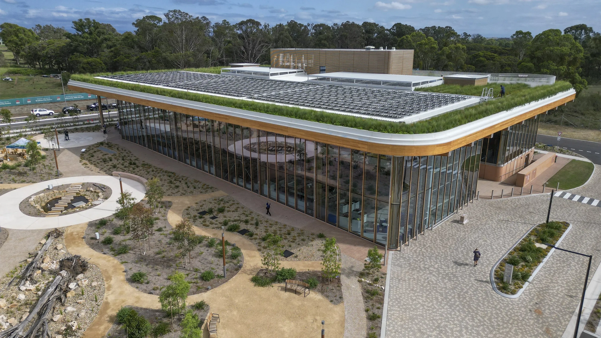 BDA first building with green grass on roof and glass windows.